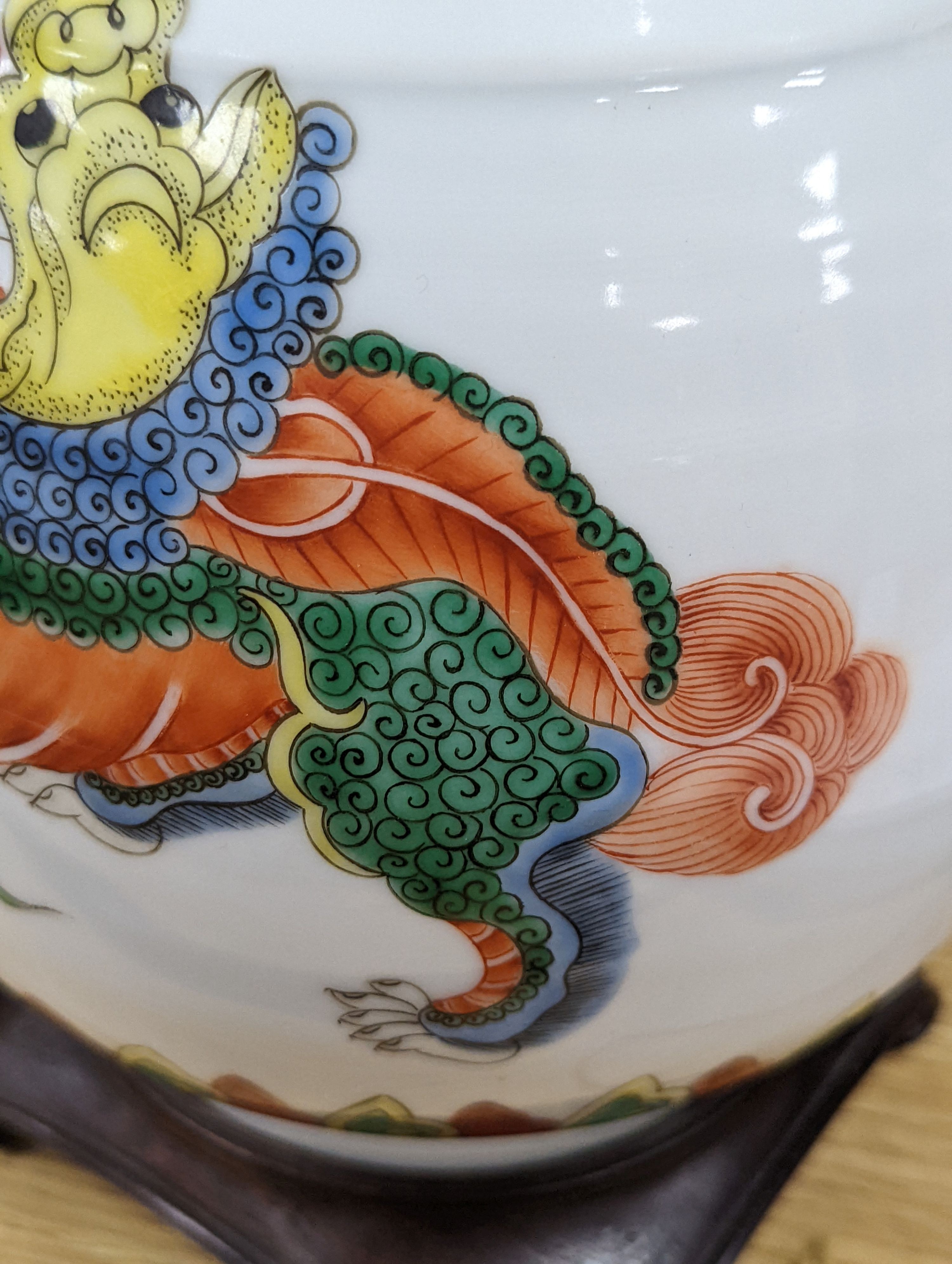 A Chinese famille verte pear shaped ‘Buddhist lion’ vase, on stand, 32 cms high not including stand.